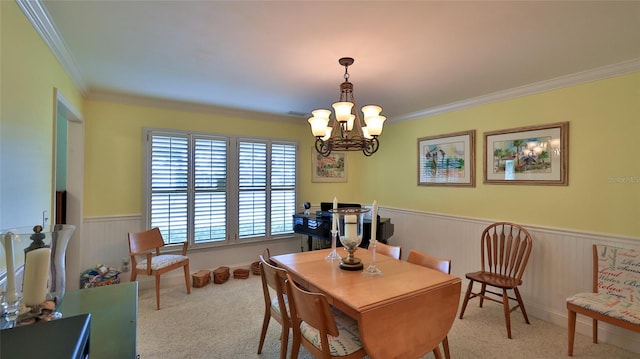 carpeted dining area with a notable chandelier and ornamental molding