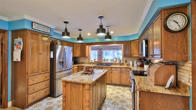 kitchen with sink, a center island, ornamental molding, and appliances with stainless steel finishes