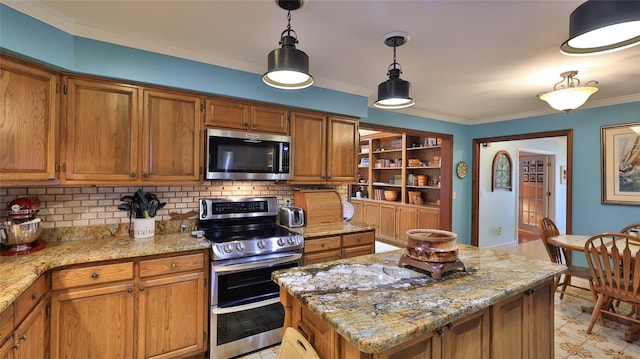 kitchen featuring light stone counters, pendant lighting, a kitchen island, and stainless steel appliances