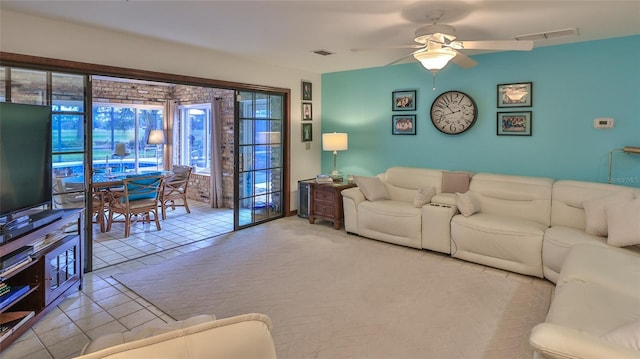 tiled living room with ceiling fan