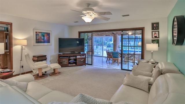 carpeted living room featuring ceiling fan