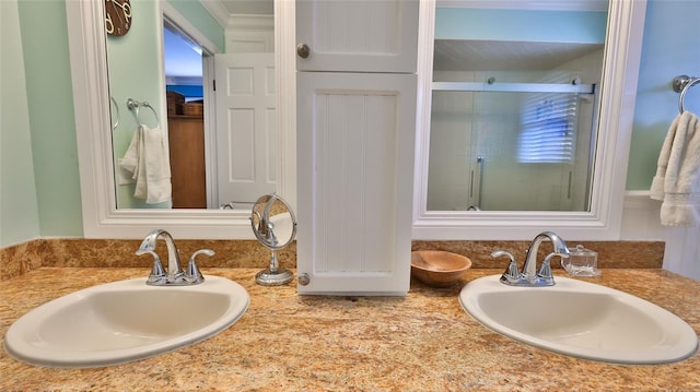 bathroom featuring vanity and a shower with shower door