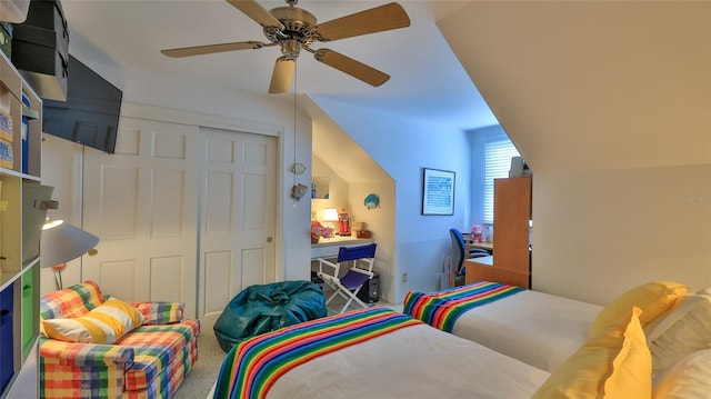 carpeted bedroom featuring ceiling fan, lofted ceiling, and a closet