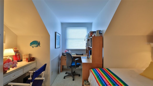 office area with light colored carpet and vaulted ceiling