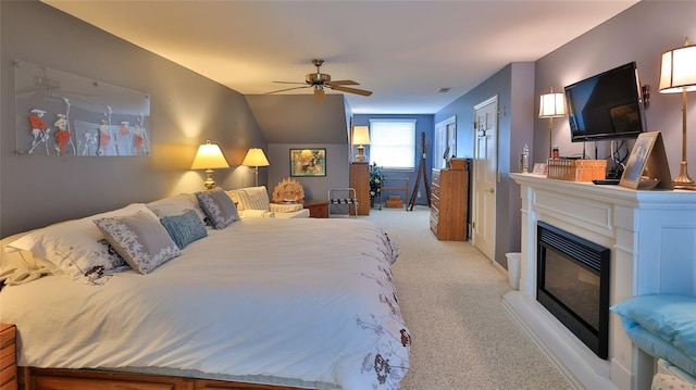 bedroom featuring ceiling fan, light colored carpet, and lofted ceiling