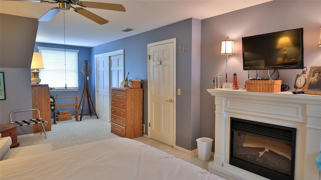 bedroom with ceiling fan and light carpet