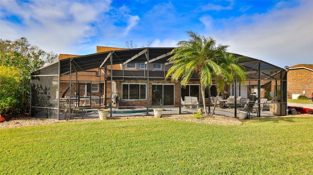 back of property featuring a lawn, a patio area, and glass enclosure