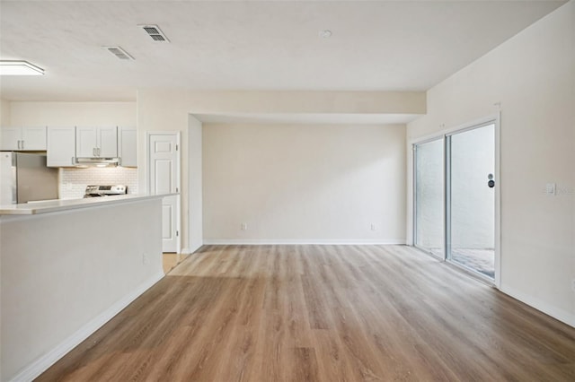 unfurnished living room featuring light hardwood / wood-style floors