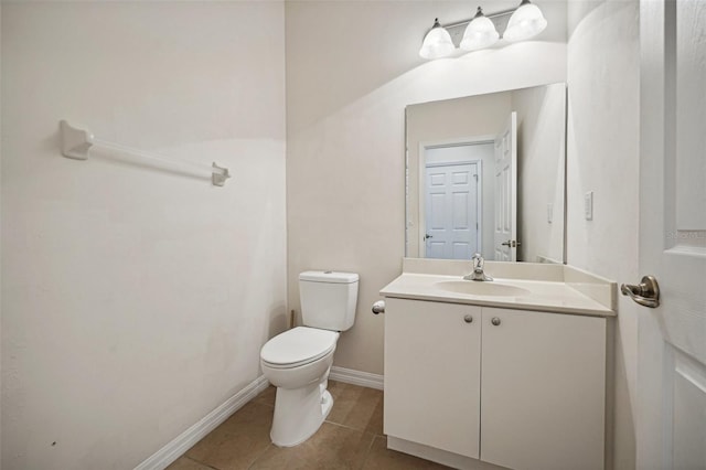 bathroom with tile patterned flooring, vanity, and toilet