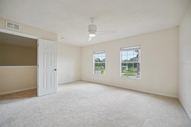 empty room featuring light carpet and ceiling fan