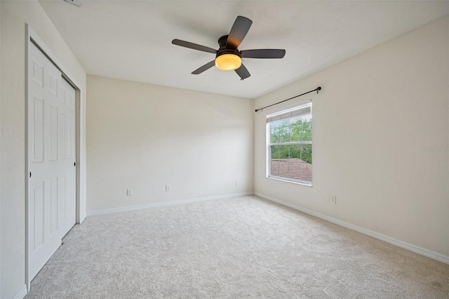 unfurnished bedroom with carpet, ceiling fan, and a closet