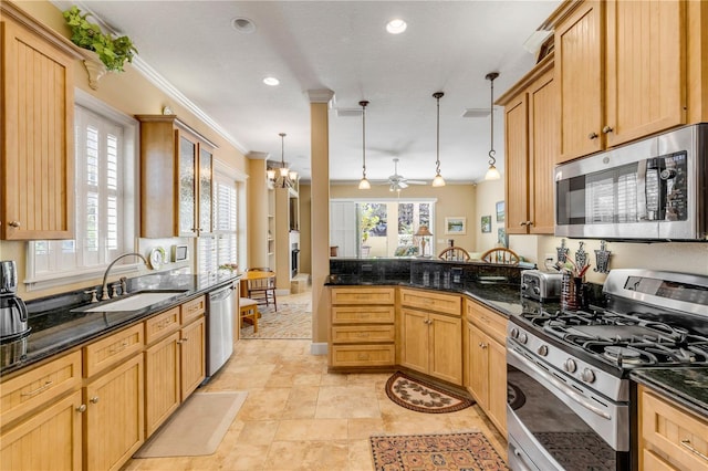 kitchen featuring sink, stainless steel appliances, crown molding, dark stone counters, and pendant lighting