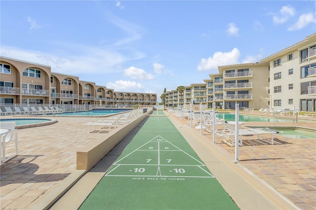 view of community featuring a pool with hot tub