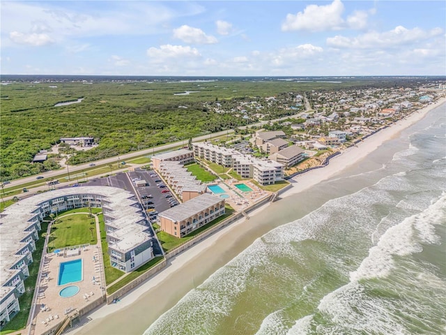 birds eye view of property featuring a water view and a view of the beach