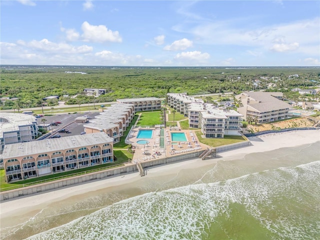 birds eye view of property featuring a water view and a beach view