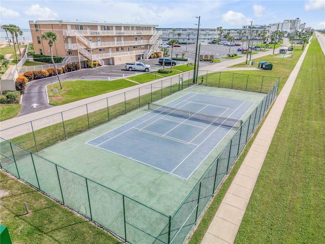 view of sport court featuring a yard