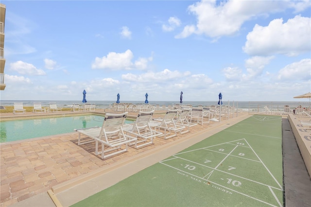 4811 Saxon Dr Unit C102, New Smyrna Beach, FL 32169 - surrounding community with shuffleboard and a water view