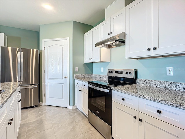 kitchen featuring light stone counters, white cabinetry, stainless steel appliances, and light tile patterned floors