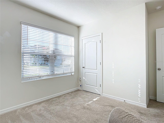 unfurnished bedroom with light colored carpet