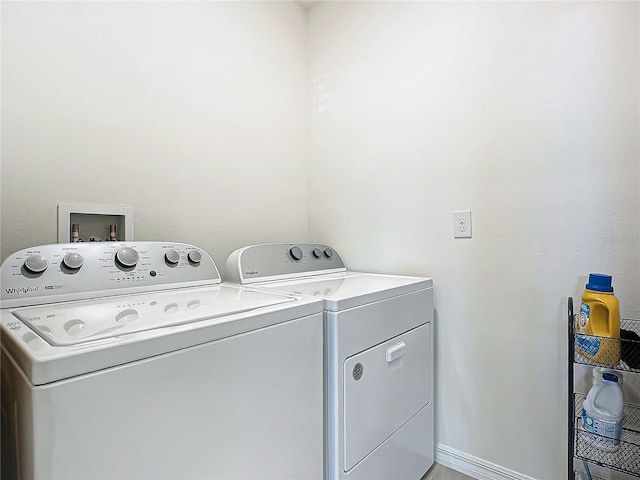 laundry area with independent washer and dryer