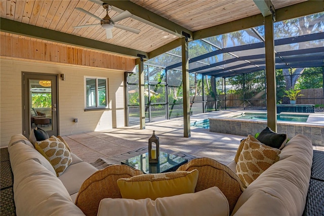 view of patio / terrace with a pool with hot tub, glass enclosure, ceiling fan, and an outdoor hangout area