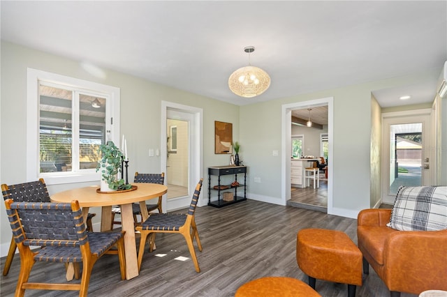 dining area featuring dark hardwood / wood-style flooring and a chandelier