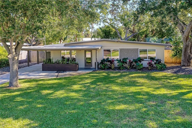 single story home with a front yard and a carport