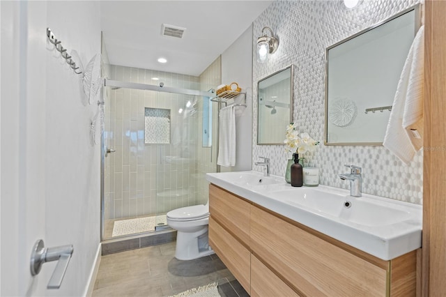 bathroom featuring walk in shower, tile patterned floors, toilet, decorative backsplash, and vanity