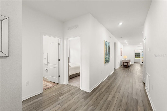 corridor with hardwood / wood-style floors