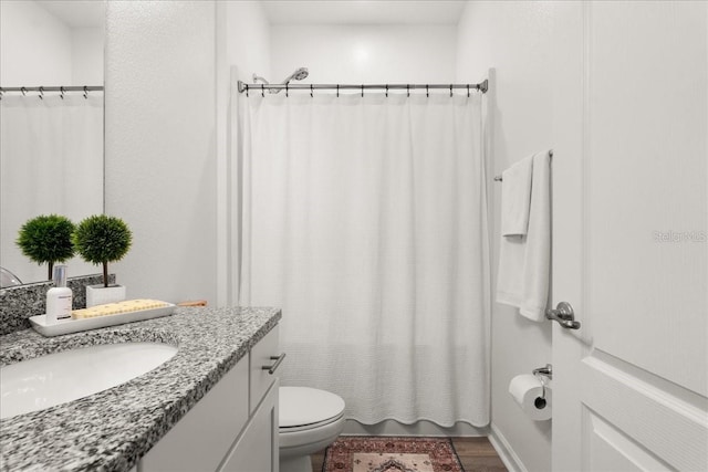 bathroom with hardwood / wood-style floors, vanity, and toilet