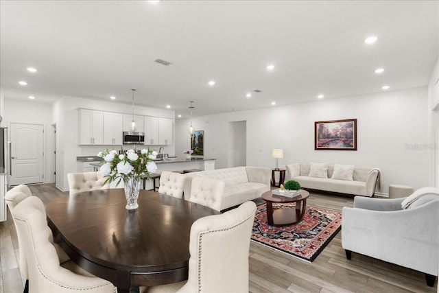 dining space featuring light wood-type flooring