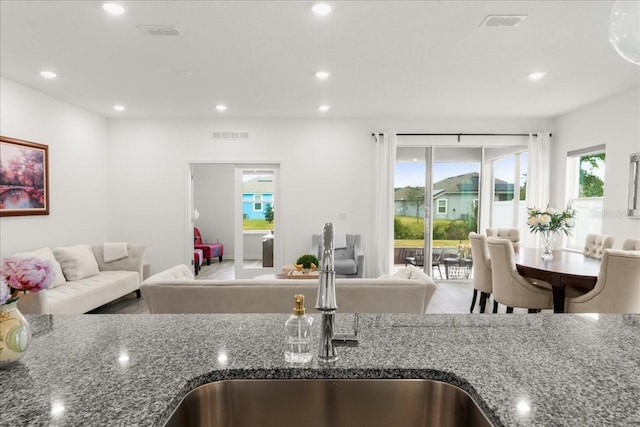 kitchen with stone countertops and sink