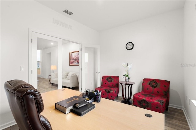 home office with hardwood / wood-style floors