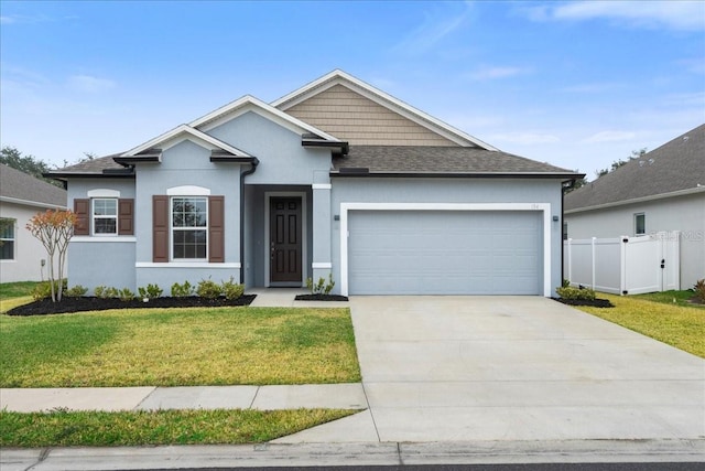 view of front of home with a front yard and a garage