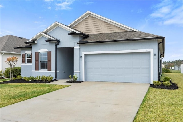 view of front of house with a front yard and a garage