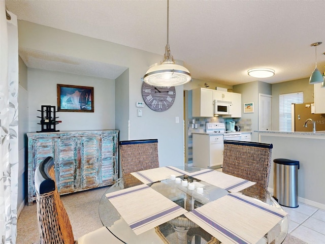 dining room featuring baseboards and a textured ceiling