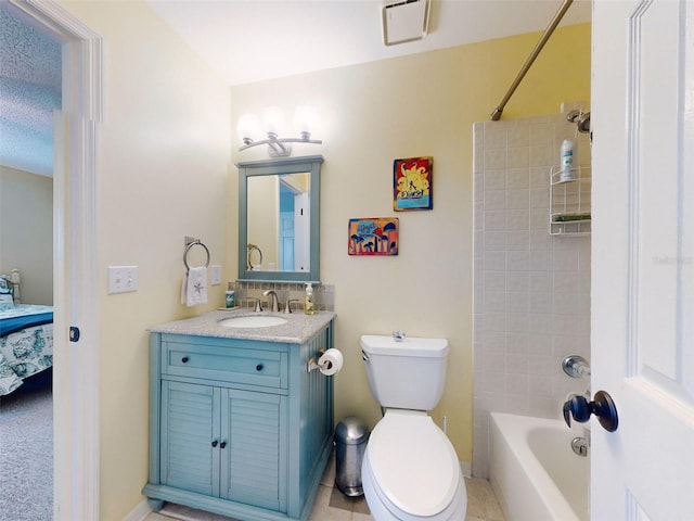 full bathroom featuring toilet, ensuite bathroom, washtub / shower combination, vanity, and baseboards