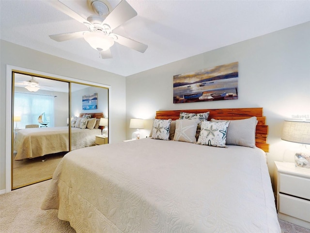 bedroom featuring a ceiling fan, a closet, and light colored carpet