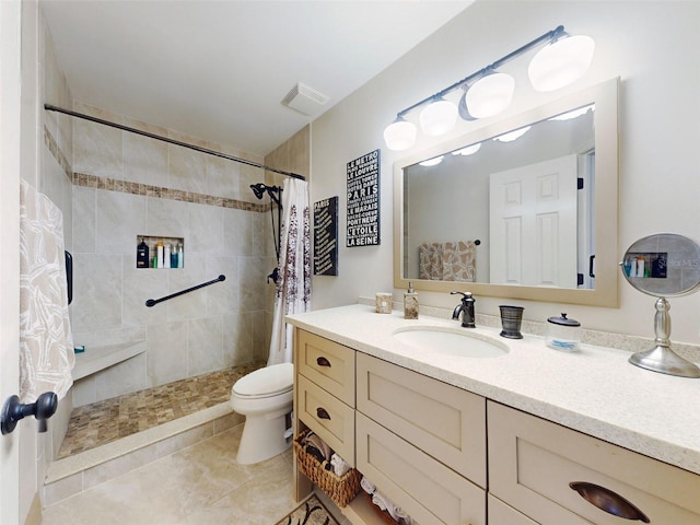 full bath with visible vents, tiled shower, vanity, and toilet