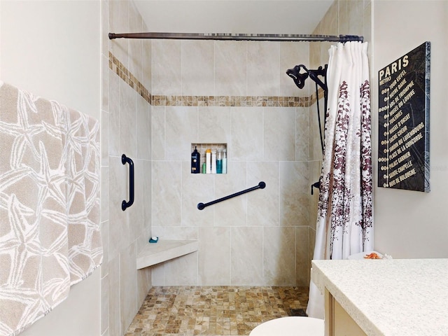 bathroom featuring a stall shower, vanity, and toilet