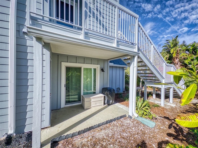 exterior space featuring board and batten siding and a patio