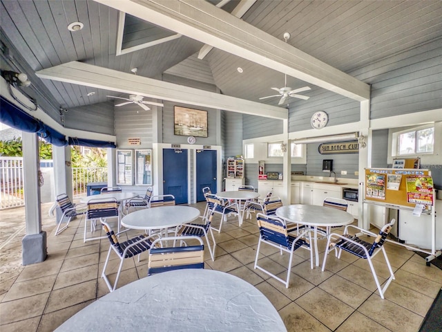 interior space with a ceiling fan, outdoor dining space, a sink, and fence