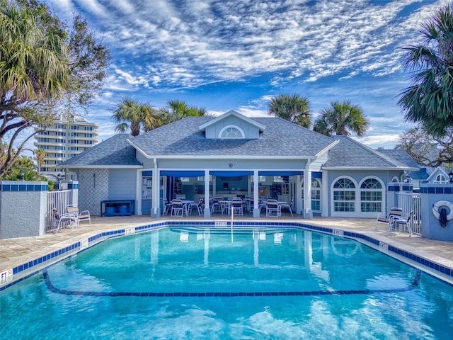 pool featuring a patio and fence