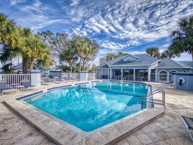 community pool featuring a patio area and fence