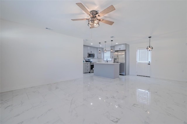 unfurnished living room with ceiling fan and sink