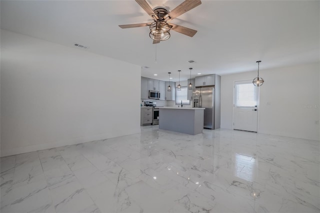 unfurnished living room featuring ceiling fan and sink