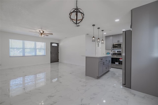 kitchen with gray cabinets, ceiling fan, a center island, and appliances with stainless steel finishes