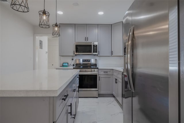 kitchen with appliances with stainless steel finishes, gray cabinets, and hanging light fixtures