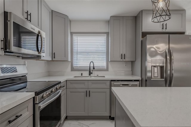 kitchen featuring gray cabinets, sink, and appliances with stainless steel finishes