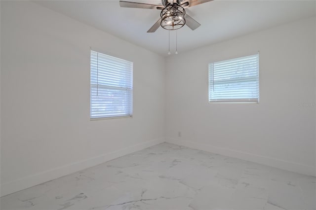 empty room featuring plenty of natural light and ceiling fan